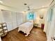 Bedroom features closet, ceiling fan, wood floors, and a window at 5350 Barbarossa Ave, Sarasota, FL 34235