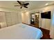 Bright bedroom features a wood-frame bed, ceiling fan, and wood-look laminate flooring at 5350 Barbarossa Ave, Sarasota, FL 34235
