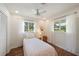Bright bedroom with two large windows, ceiling fan, and vinyl flooring at 5350 Barbarossa Ave, Sarasota, FL 34235