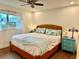 Bedroom with a wooden bed frame, wood flooring, and a ceiling fan at 5350 Barbarossa Ave, Sarasota, FL 34235