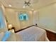 Bedroom featuring a ceiling fan, window, and door at 5350 Barbarossa Ave, Sarasota, FL 34235