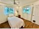 Bright bedroom features wood floors, ceiling fan, and two windows at 5350 Barbarossa Ave, Sarasota, FL 34235