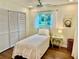 Cozy bedroom featuring wood floors, closet, ceiling fan, and a window view at 5350 Barbarossa Ave, Sarasota, FL 34235
