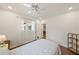 Bright bedroom featuring a twin bed, wood floors, ceiling fan, closet and a bright window with natural light at 5350 Barbarossa Ave, Sarasota, FL 34235