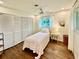 Well-lit bedroom boasts a ceiling fan, closet, wood floors, and natural light from the window at 5350 Barbarossa Ave, Sarasota, FL 34235