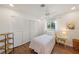 Cozy bedroom featuring a twin bed, ceiling fan, wood floors, closet and a bright window with natural light at 5350 Barbarossa Ave, Sarasota, FL 34235