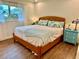 Relaxing bedroom featuring wood floors, large window and blue accent furniture at 5350 Barbarossa Ave, Sarasota, FL 34235