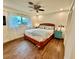 Bright bedroom with wood floors, ceiling fan, large window and ocean themed bedding at 5350 Barbarossa Ave, Sarasota, FL 34235