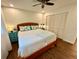 Bright bedroom features a wood-frame bed, ceiling fan, and wood-look laminate flooring at 5350 Barbarossa Ave, Sarasota, FL 34235
