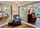 Charming bonus room with access to the bedroom and living room. Accent chair and a footstool adds comfort at 5350 Barbarossa Ave, Sarasota, FL 34235