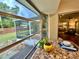 View of breakfast nook, with granite countertop and sliding glass doors to main bedroom and screened in porch at 5350 Barbarossa Ave, Sarasota, FL 34235