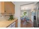 Bright dining area adjacent to the kitchen, featuring a round glass table and stylish decor at 5350 Barbarossa Ave, Sarasota, FL 34235