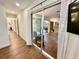 Hallway with hardwood floors looking into the bright living room featuring lots of natural light at 5350 Barbarossa Ave, Sarasota, FL 34235