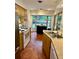 Bright kitchen with stainless steel appliances, terracotta tile floor, and breakfast nook with a view at 5350 Barbarossa Ave, Sarasota, FL 34235