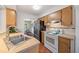 Charming kitchen featuring stainless steel appliances and warm wood cabinetry at 5350 Barbarossa Ave, Sarasota, FL 34235
