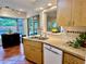 Galley kitchen featuring tile floors, stainless steel sink, and modern appliances offering backyard view at 5350 Barbarossa Ave, Sarasota, FL 34235