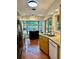 Well-lit kitchen with stainless steel appliances, wood cabinets, tiled flooring, and a corner window adding natural light at 5350 Barbarossa Ave, Sarasota, FL 34235