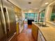 Spacious kitchen featuring stainless steel appliances, a breakfast nook with a backyard view, and ample counter space at 5350 Barbarossa Ave, Sarasota, FL 34235