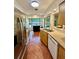 Well-lit kitchen with stainless steel appliances, terracotta tile floor, and a breakfast nook with a view at 5350 Barbarossa Ave, Sarasota, FL 34235