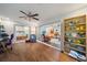 Open-concept living area with wood floors, shelving, and sliding glass doors to other rooms at 5350 Barbarossa Ave, Sarasota, FL 34235