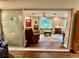 Bright living room features a comfortable yellow sofa and natural light coming in from large windows at 5350 Barbarossa Ave, Sarasota, FL 34235