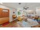 Cozy living room with hardwood floors, natural light, and an adjacent dining area at 5350 Barbarossa Ave, Sarasota, FL 34235