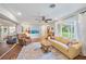 Bright living room with hardwood floors, cozy seating, and natural light from large windows at 5350 Barbarossa Ave, Sarasota, FL 34235