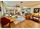 Spacious living room with hardwood floors, ample seating, ceiling fan, and dining area at 5350 Barbarossa Ave, Sarasota, FL 34235