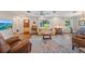 Open living room with hardwood floors, casual furniture and a view into the dining area at 5350 Barbarossa Ave, Sarasota, FL 34235