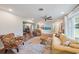 Spacious living area with hardwood floors, a ceiling fan and access to another room at 5350 Barbarossa Ave, Sarasota, FL 34235