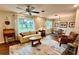Cozy living room featuring a ceiling fan, a comfortable sofa, and a dining area at 5350 Barbarossa Ave, Sarasota, FL 34235