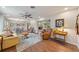 Open-concept living room, dining area with hardwood floors and a ceiling fan at 5350 Barbarossa Ave, Sarasota, FL 34235