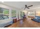 Bright sunroom with desk, bench, windows and sliding glass door leading to bedroom at 5350 Barbarossa Ave, Sarasota, FL 34235