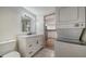 Bathroom featuring a vanity with white cabinets, marble countertop, and adjacent laundry area at 5438 Potter St, Sarasota, FL 34232