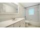 Bright bathroom featuring a bathtub, tile, and a vanity with ample storage at 5438 Potter St, Sarasota, FL 34232