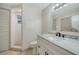 Bathroom with marble countertop, modern fixtures, and a shower with tiled walls at 5438 Potter St, Sarasota, FL 34232