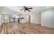 Spacious living room featuring open floor plan with wood flooring, ceiling fan, and stainless steel appliances at 5438 Potter St, Sarasota, FL 34232