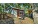 Backyard shed with a mix of wood and metal siding near a wood picket fence at 5438 Potter St, Sarasota, FL 34232