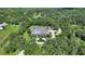 Aerial view of estate home on large lot showcasing mature landscaping, long driveway, and overall privacy at 6050 Saddle Oak Trl, Sarasota, FL 34241