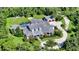 Expansive aerial view of estate home and surrounding manicured lawns, lush landscaping and private grounds at 6050 Saddle Oak Trl, Sarasota, FL 34241