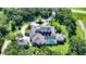 Expansive property with a screened pool area, detached garage, and a picturesque setting surrounded by lush trees at 6050 Saddle Oak Trl, Sarasota, FL 34241