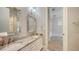Bathroom with double sink vanity with marble countertops and decorative mirrors at 6050 Saddle Oak Trl, Sarasota, FL 34241
