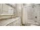 Bathroom featuring a marble countertop and shower with glass door at 6050 Saddle Oak Trl, Sarasota, FL 34241