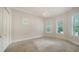 Bright bedroom with carpet, large windows, blinds, chandelier, and neutral paint at 6050 Saddle Oak Trl, Sarasota, FL 34241