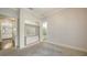 Bedroom with neutral walls, carpet, a closet, and a door that leads to the bathroom at 6050 Saddle Oak Trl, Sarasota, FL 34241