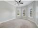 Spacious bedroom with carpet and three large windows with exterior views at 6050 Saddle Oak Trl, Sarasota, FL 34241