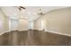 Bonus room with wood floors, ceiling fans, and windows with blinds at 6050 Saddle Oak Trl, Sarasota, FL 34241