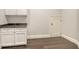 Butlers pantry with granite counters, white cabinets, and dark wood flooring at 6050 Saddle Oak Trl, Sarasota, FL 34241