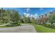 Beautiful front yard featuring a circular driveway and lush green landscaping, creating a welcoming entrance at 6050 Saddle Oak Trl, Sarasota, FL 34241