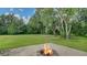 Cozy backyard fire pit area surrounded by lush greenery, ideal for relaxing evenings at 6050 Saddle Oak Trl, Sarasota, FL 34241